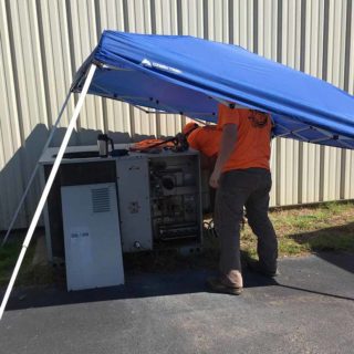 Hard at work on customer's air conditioning unit
