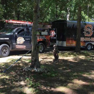 The Sisco Heat & Air truck and trailer in park