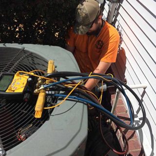 Technician working on a customer's air conditioner