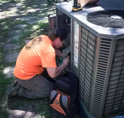 This Sisco Heat & Air technician performs seasonal preventive maintenance on an HVAC unit.